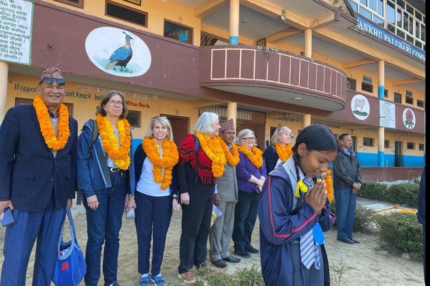 The Adovcates in front of the school.